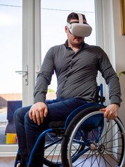 Man on wheelchair with VR goggles at home