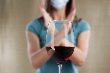 reject liquor, stop alcohol, teenager girl shows a sign of refusal of wine