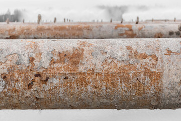 Old steel rusty abandoned pipes of the water cooling pipeline system of the combined heat and power industrial plant