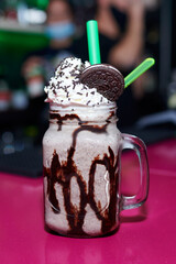 A vertical shot of delicious chocolate milkshake in the cafe