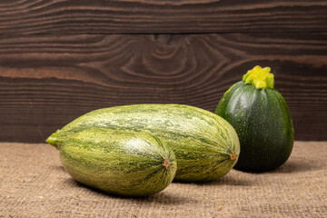 zucchini of different varieties on a wooden background