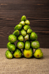 a pile of fresh cucumbers  on a wooden background
