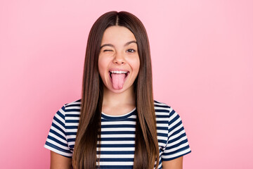 Fototapeta Photo of pretty funny impressed girl wear striped outfit winking showing tongue isolated pink color background obraz
