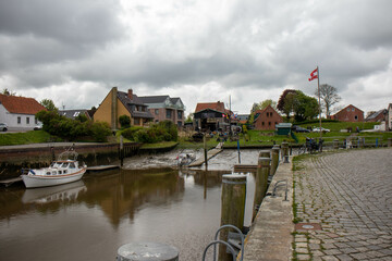 Historical buildings, churches and harbor facilities at low tide in Tönning, Schleswig Holstein, Germany,a