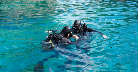Initial immersion with an instructor underwater, breathing training under water. First time scuba...