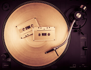A needle on a turntable that plays music