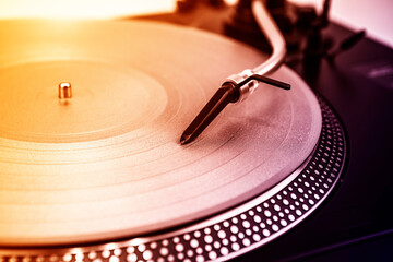 A needle on a turntable that plays music
