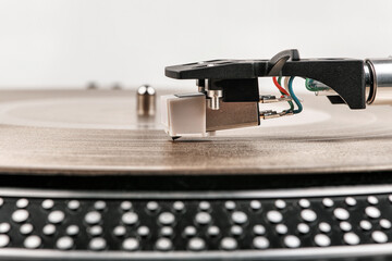A needle on a turntable that plays music