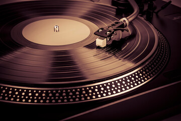 A needle on a turntable that plays music
