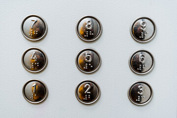 A close shot of the elevator buttons. Housing and communal services. Minimalistic design. Font for...