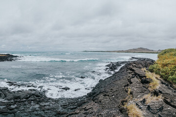 Scenic view of the rugged coastline and crashing waves at Isla Isabela, Galapagos, Ecuador,