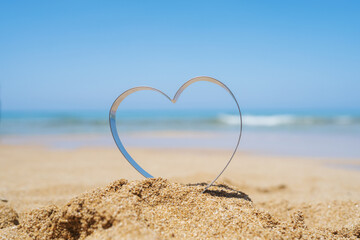 Fototapeta na wymiar Sea view through shape of heart in the sand of tropical beach. Valentines day. Holiday, vacation concept. Creative, background, copy space, travel, summer.