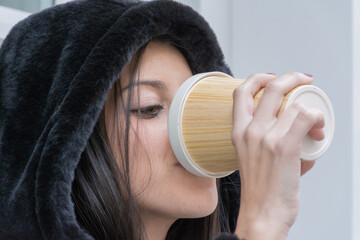 Woman drinking take away coffee