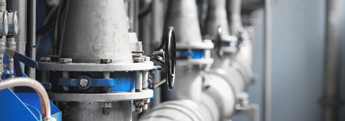 Large industrial water treatment and boiler room. Piping, flanges, butterfly valves, rusty and...