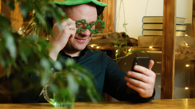 St Patrick Day Concept. Man Celebrating Saint Patricks Day At Home, Having Video Call Using Smartphone.