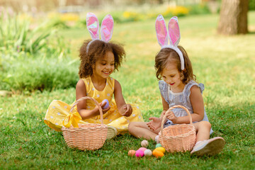 children find and pick up multicolored egg on Easter egg hunt