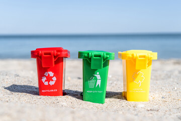Different colored trash cans with paper, plastic, glass and organic waste suitable for recycling on...