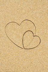 Hand-drawn shape of two heart on sand tropical beach. valentines day. Holiday concept. Creative, background, copy space, travel, summer. Flat lay