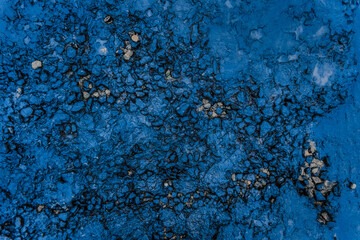 Fuel pollution soil dirt oil blue rough stone surface of the earth toxic industry dark rock background