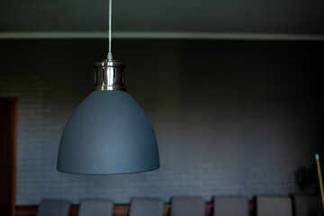 Obraz premium Close up of black stylish lamp hang over billiard table. Leisure activity interior design elements. selective focus