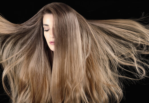 Woman with long straight hair flying around head. Beautiful model girl with healthy shiny ash blonde hair