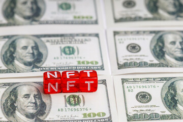 NFT word on red cubes found on one hundred dollar bills