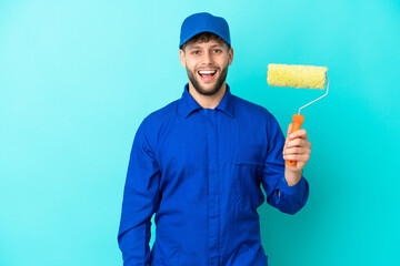 Painter caucasian man isolated on blue background with surprise facial expression