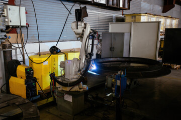 Industrial robot is welding metal machine part