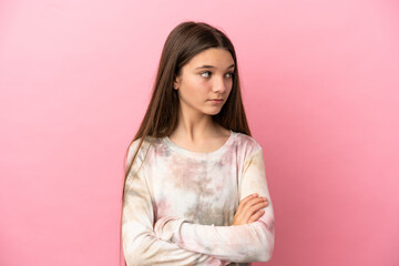 Little girl over isolated pink background keeping the arms crossed