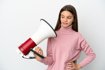 Little girl over isolated white background holding a megaphone with stressed expression