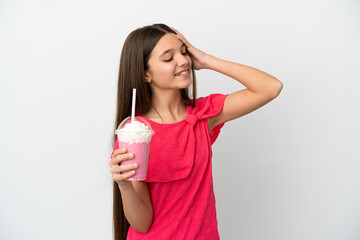 Little girl with strawberry milkshake over isolated white background smiling a lot