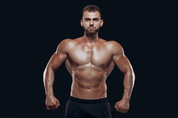 Fototapeta na wymiar Sportive man workout with heavy weight disc. Photo of athletic young man with naked torso and good physique on white background. Strength and motivation