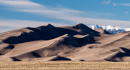Prevailing winds from the south west have created Great Sand Dunes National Park and Preserve. North America's tallest dunes in a vast 30 square mile dunefield on a high-altitude desert region.