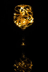 Fairy Light in a wine glass, in the Dark, Low-Key Photography.