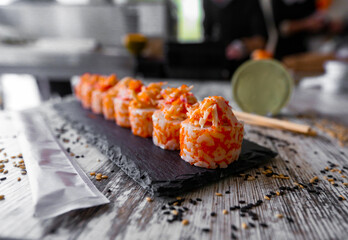 Crab sticks Sushi Japanese Food Style, Crab sticks Sushi roll on the black desk © Anton