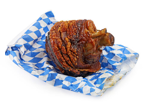 crispy roasted pork knuckle on bavarian warming grill bag isolated on white background