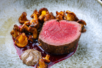 Modern style traditional barbecue dry aged angus beef tenderloin steak natural with chanterelle...