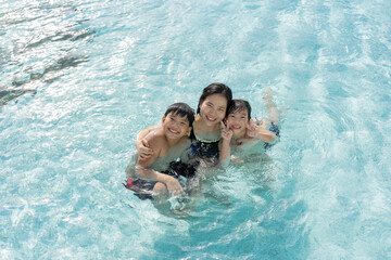 Asian Family, Young Boy Son and 40s Women Mother Having a Good Time Playing and Enjoying in Swimming Pool - 486348383