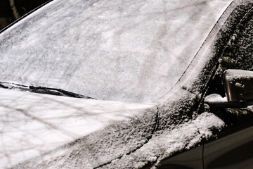 car windshield covered with a thick layer of snow after storm outside