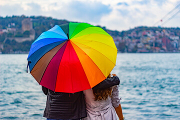 Boy and girl with colorful umbrella