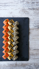Sushi Set nigiri and sushi rolls on black stone slate plate board top view