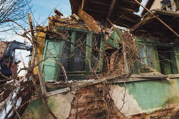 Collapsing old house being demolished.