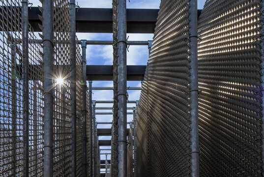 Large Empty Stainless Steel And Aluminum Rock Cages For Coastal Engineering Projects, Daytime, Sun Flare, Nobody