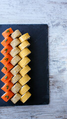 Sushi Set nigiri and sushi rolls on black stone slate plate board top view