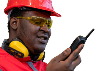 Black Worker In Protective Workwear With Radio Communication Equipment Isolated On White Background. Portrait Of Industrial Worker In Red Helmet, Safety Goggles And Hearing Protection Equipment.