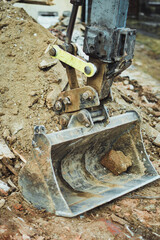 Digger bucket with rubble. House demolition. 