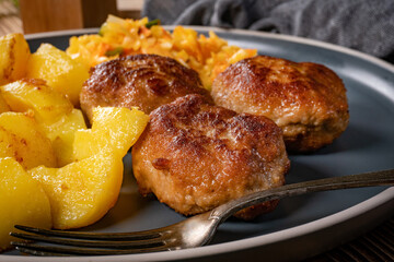 Meatballs  served with fired potatoes.