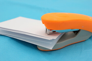 Stapling sheets of paper with an orange stapler