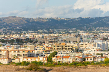 Obraz premium The city of Paphos in the setting sun from the coast. Late autumn in Cyprus.