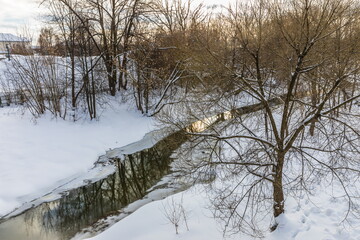 The Vokhonka river in winter in the historical center of the small district town of Pavlovsky Posad, Russia